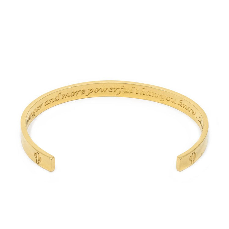 Jewmei gold cuff bracelet showing engraved words, "you are more powerful than you know. Keep going."
