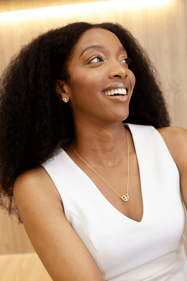 Woman wearing Jewmei Heart Cross Stud Earrings