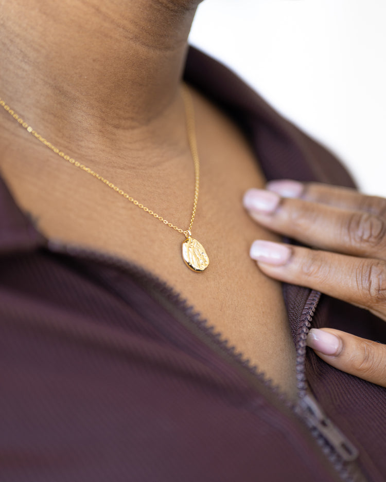 Woman wearing a meaningful necklave from Jewmei