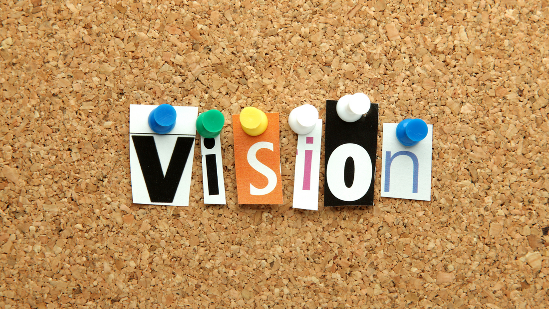 Image of letters pinned to a board spelling out "vision" to encourage setting and achieving goals