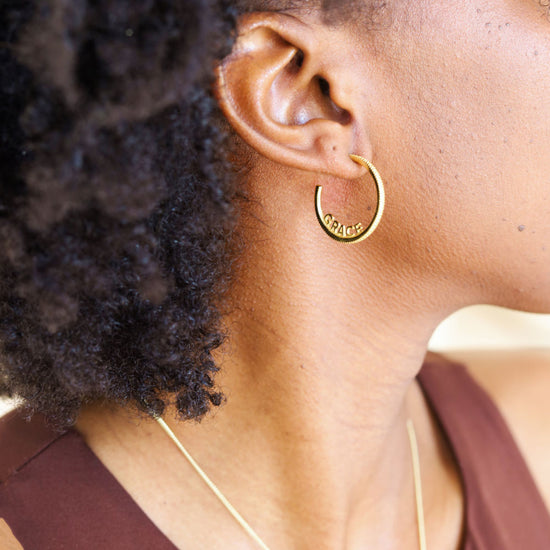 Woman wearing 'Give Yourself Grace' Gold Hoop Earrings - Symbolic Jewelry with Meaning - Empowering Self-Compassion and Style