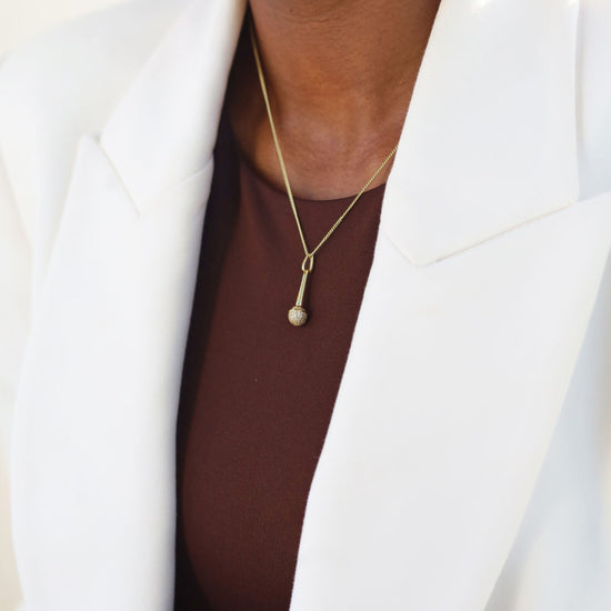 Women in professional attire wearing the Speak Up 14k gold over 925 Sterling Microphone Necklace from Jewmei Graduation jewelry.