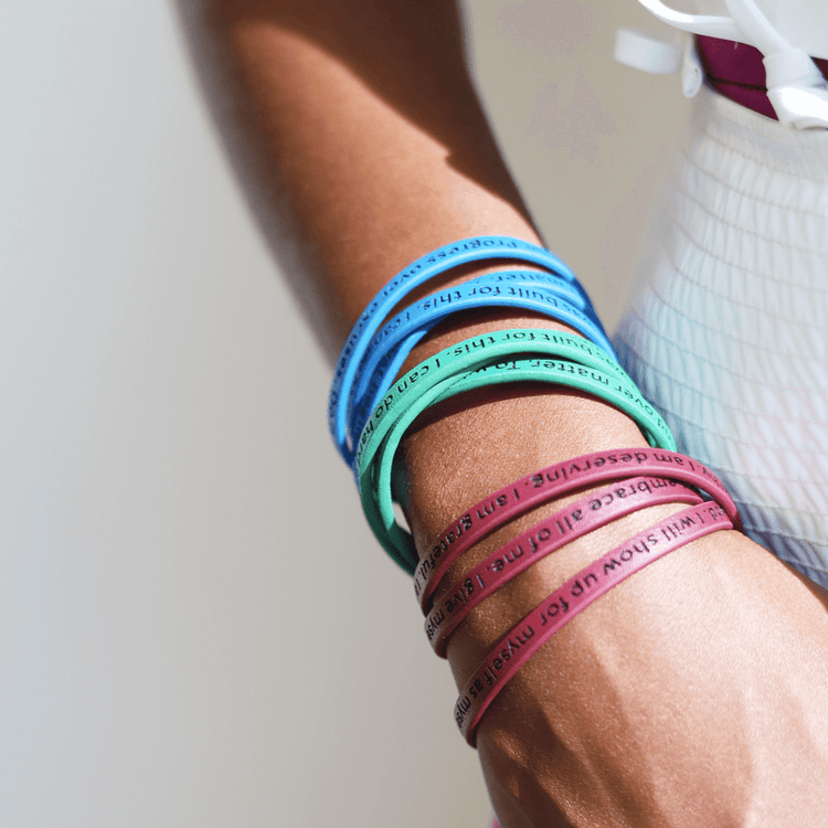 Woman wearing three vegan leather wrap bracelets from Jewmei