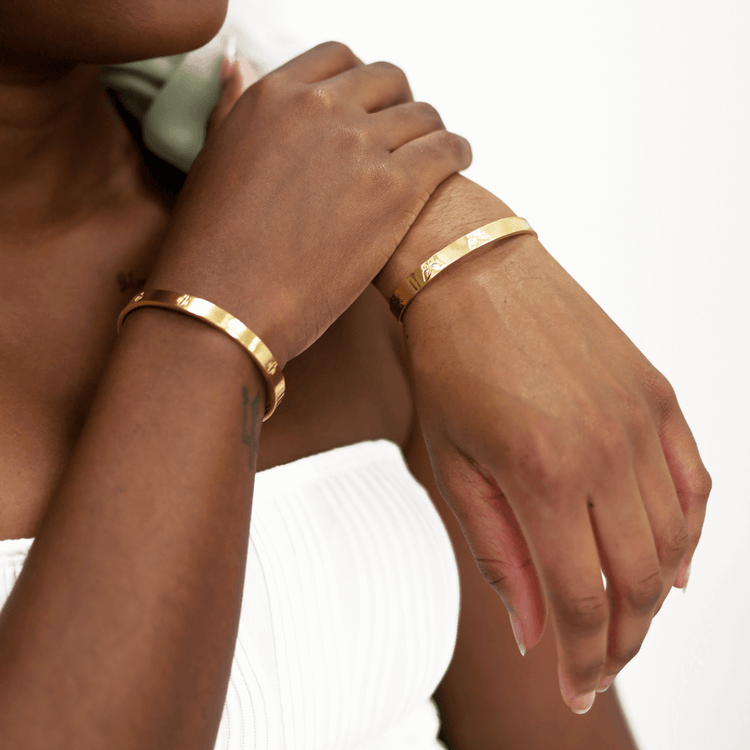 Two females wearing the adjustable cuff gold bracelet from Jewmei.