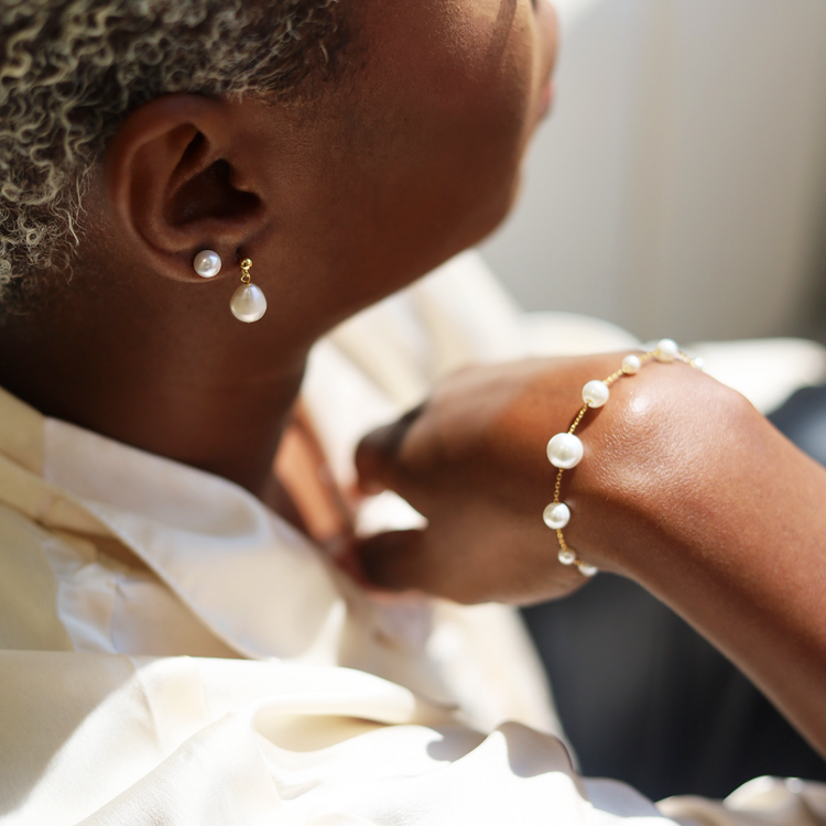 Woman wearing pearl bracelet and earrings 